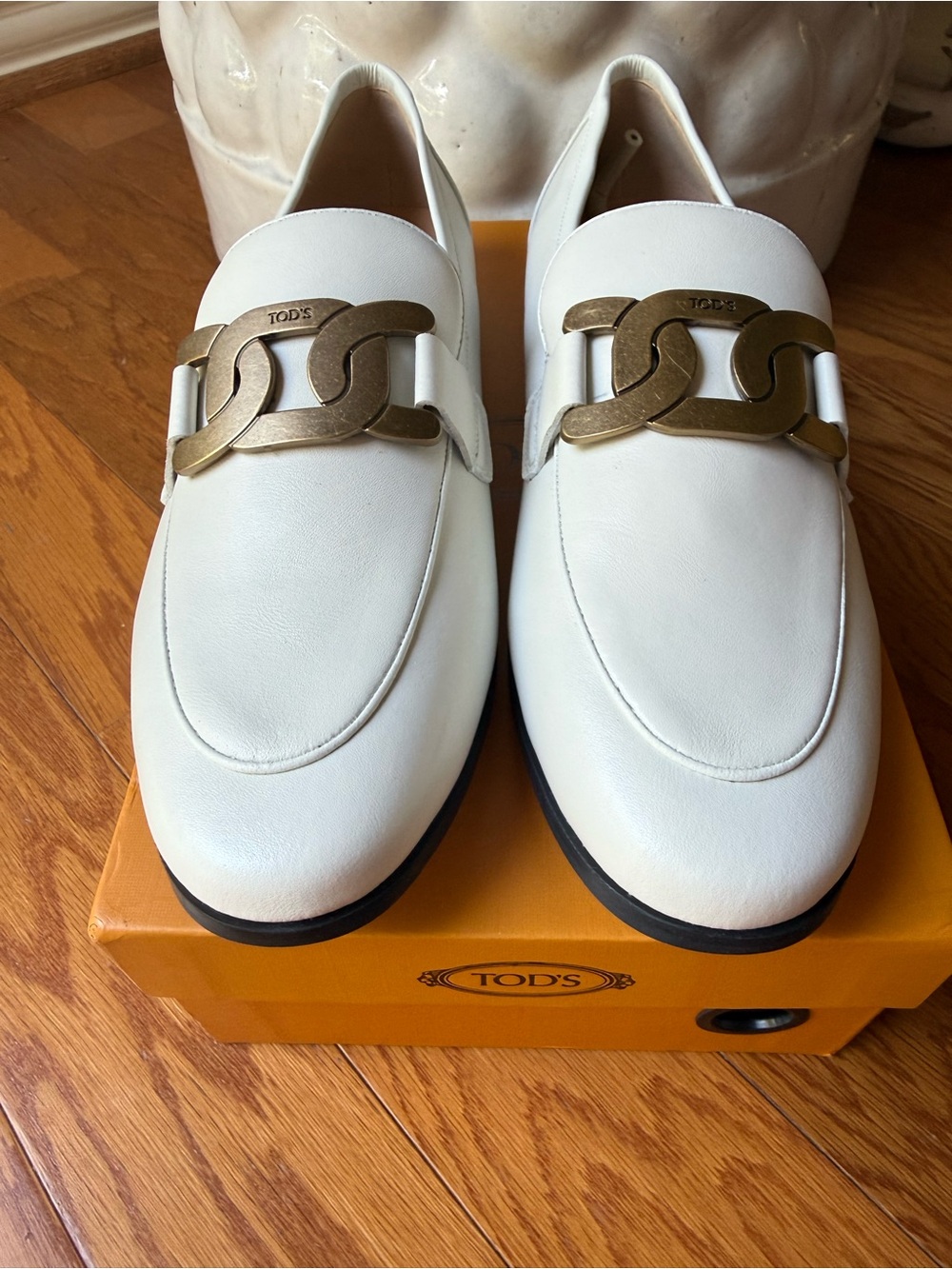 Tod’s White Italian Leather Kate Loafer With Antique Gold Metal Buckle.